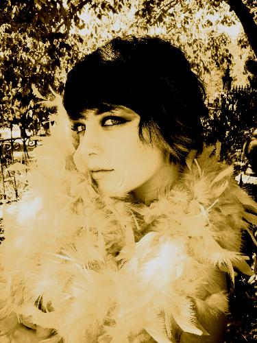 Kayla in feathers - I am a photographer that likes to take unusual pictures. This is one of my favorites. It is fun to make photos look like it was taken in the old days. I took this one at a graveyard dated from the 1800's to now. A Masonic Cemetary in Sonora, CA to be exact.