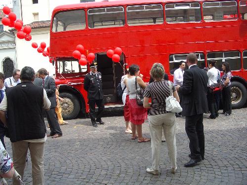 people - people near an english bus. but in italy