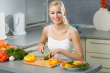 Women making salad - This photo shows the young happy women making salad in the kitchen.