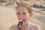Girl  - This is the photo of the girl enjoying and eating an icecream.