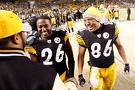 All smiles - They must have just made a good play. Now they are noting but smiles coming off the field. We all know how much Hines Ward smiles ;)