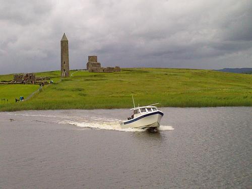 Devenish Island Ferry,Lough Erne,County Fermanagh, - With the 12th Century Devenish Island Monastic site in the background.