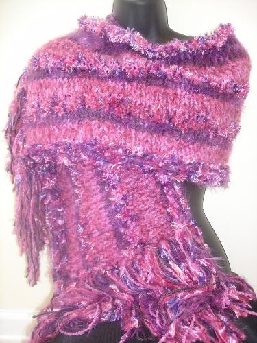 Hand Knitted Wrap in Pinks - My hand knitted shawl/wrap in shades of pink, mauve, and plum. Knitted in stripes with various yarns (feather boa, brushed acrylic/mohair, eyelash).
