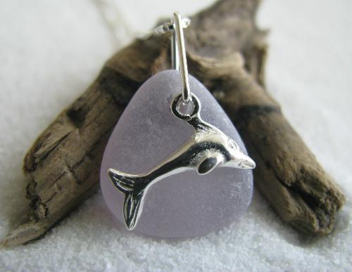 Lavender Sea Glass Necklace with Dolphin - A pretty lavender piece of sea glass, measuring 5/8' in length, is accented with a small sterling silver dolphin charm. The pendant hangs on an 18' sterling silver Venetian box-style chain.