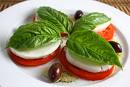 Caprese Salad - This is the photo of the caprese salad. A caprese salad or insalata caprese is a simple salad consisting of fresh tomatoes , mozzarella and basil. The salad is seasoned with olive oil , salt and pepper .