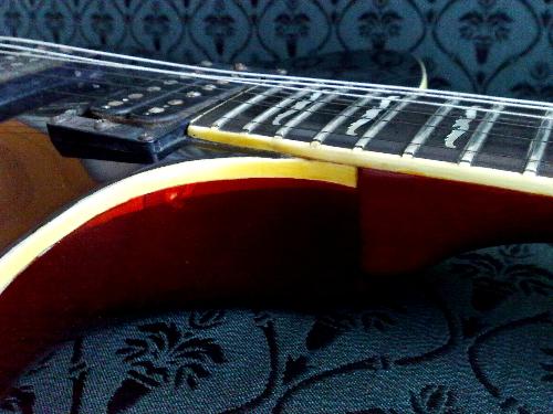 red guitar - color brown guitar but when light gets into it, it turns to dark red.