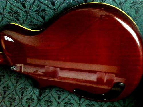 brown guitar - brown guitar, so shiny that when lights was focus, it reflect a mahogany color