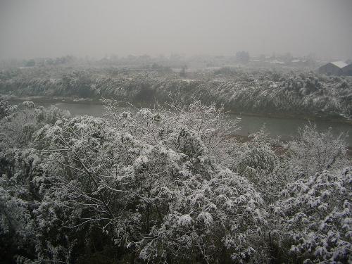 another photo of snow taken from my apartment wind - Outside my apartment window I can see the small river. It is very close to my window. I love the river when its sides are covered with snow and the river water is full in summer after heavy rain.