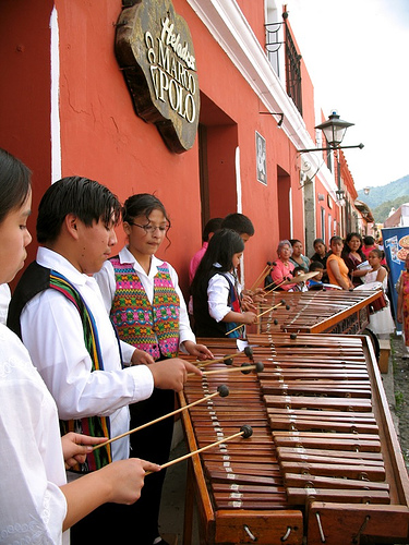 marimba - is a musical instrument in the percussion family. Keys or bars (usually made of wood) are struck with mallets to produce musical tones. The keys are arranged as those of a piano, with the accidentals raised vertically and overlapping the natural keys to aid the performer both visually and physically.