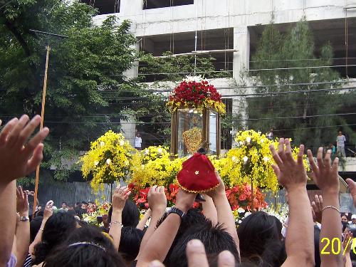Sto. Niño - people waving thier hands to the image of Sto. Niño during its parade on its annual fiesta which is celebrated evry 3rd snunday of January. Participated by people around the world. many tourists would come to celebrate its fiest.