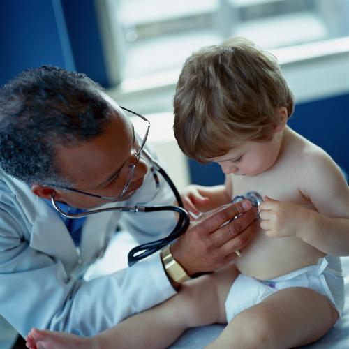 child health - a doctor playing a child