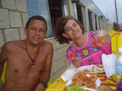 Eating prawns in Brasil - I went for a week to Camboriu, Brasil with my niece. We met a wonderful brasilian family that 'adopted' us. Here, my niece took a picture of Baiano and I eating prawns. He took us to places where tourists don´t go: less expensive and a lot better.