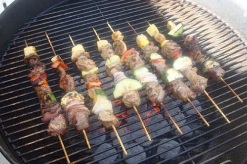 Barbecue - Barbecue being grilled with pork, cucumber, carrot, pineapple, and sweet potato