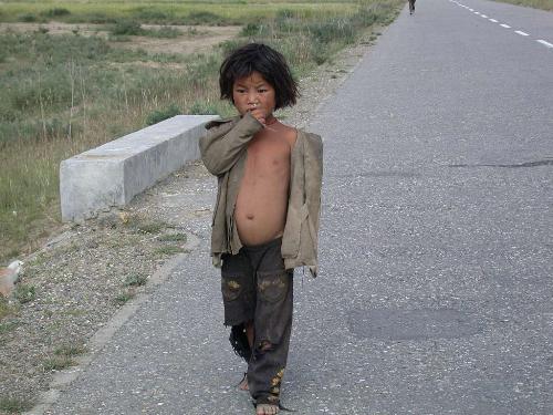 Poor Child - A poor Chinese child in the streets with no food or money.