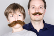 Son3 - this is the photo of the father and son with a mustache. the son is having a fake mustache