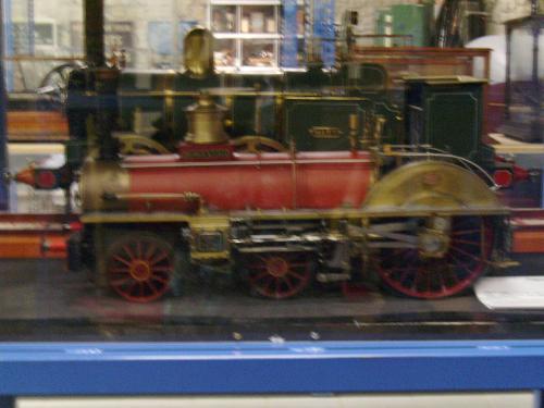 Old Train scale model 7 - Old Trains scale models from the Swindon Museum in the UK. All of them were running with coal for propulsion. This is a red one ;) and sorry for another blurry one, we tried our best to get them as well as possible on camera.