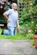 old man with back ache - this is the photo of the old man who is suffering from back ache and trying to stretch out his muscles to get relaxed from his ache