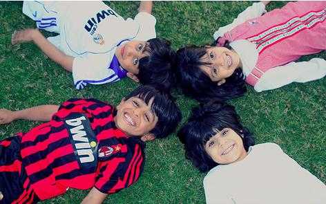 happy kids - Four happy kids lie on the grass