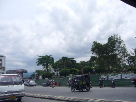 General Santos City - This was taken while I was in General Santos City. I was riding a tricycle when taking pic. Unfortunately they were making some renovations on their park, hence the green fences around it.