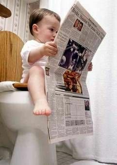 Reading newspaper in toilet - Image of a child reading newspaper in toilet.