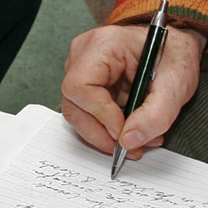 Writing - A person writing.