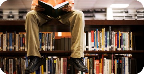 A Young Boy Reading - A young boy reading in the library.