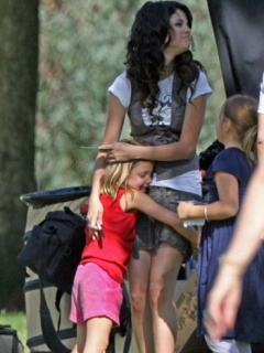 selena with kids - selena gomez can be seen with kids in the above pic and the kids seem to be enjoying her company.