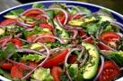 salad - A plate containing salad, tomatoes, muscles and clams.