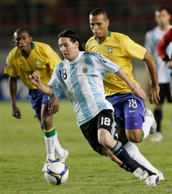 Brazil an dArgentina playing a football match - One Argentinean footballer go forward to beat Brazilian defense.