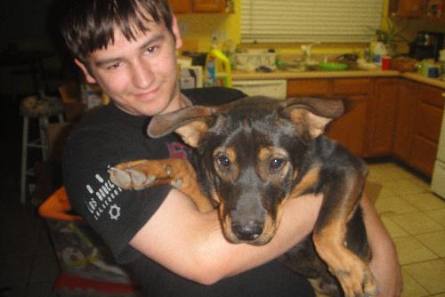 My boyfriend and my fat rotty - This is a photo of my boyfriend and our cute, affectionate and fat rottweiler.