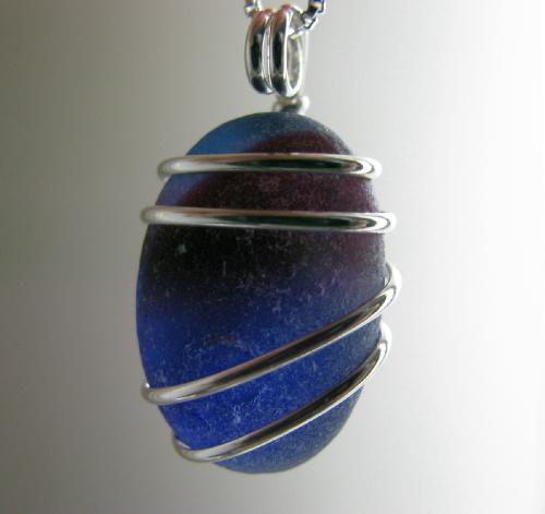 Fire and Ice Multi Sea Glass Necklace - This gorgeous piece of blue and red English 'end of day' sea glass, measuring 3/4' in length, is wrapped in sterling silver wire and hangs on a Venetian box-style sterling silver chain. When held up to a light, the colors are quite brilliant...a wonderful rare find and a necklace that is sure to turn heads!
