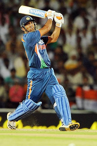 Indian captain in action - M S Dhoni punch a powerful hit for 6.