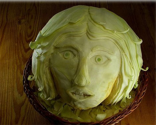 cabbage and human face - Too creative. The cabbage is sculptured into a human face.