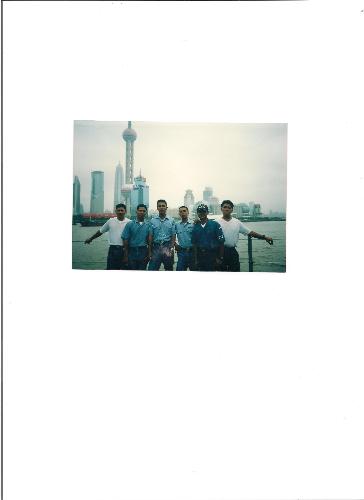 View from Shanghai, China - These are my friends, we took this photo at Yang-tse River in Shanghai, China, see the tall tower background, its almost raining on that time and the fog come close to us, it fun being there, we came to China as part of our government relation with other countries.