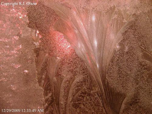 Ice crystals - I blocked the flash a bit with a finger in this shot. Some ice crystals formed on my windows in the frigid temperastures here in Minnesota.