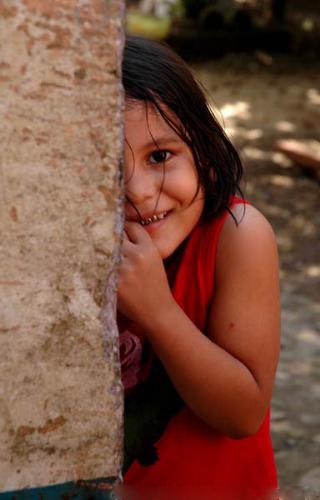 A shy girl - Children are shy at their younger age, and close their eyes when see new people