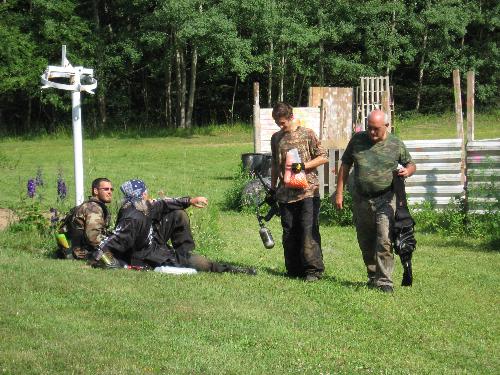 Paintball - Intermission - From left to right, Adam (my brother), Wayne, Josh (Me), and Scott (my dad)  In that photo we are sitting on the sidelines of the field since we are a bit tired from the game that we just finished.  We were mainly resting and going over the mistakes made on both sides and how to improve on it.