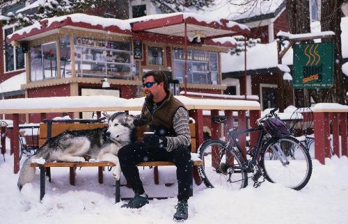 Dog and man - In snow you can drink a cup of hot coffee with your dog and touch the snow.