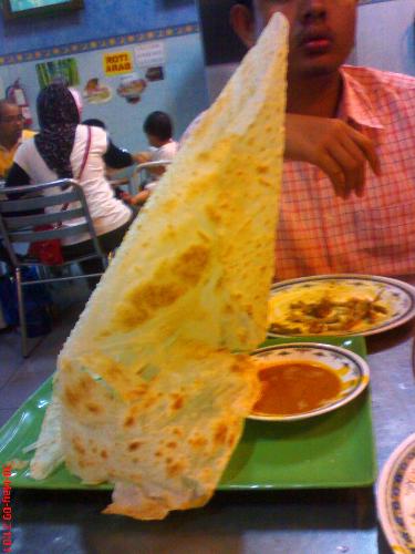 Roti Tisu - Tissue Bread - The bread is kneaded thinly and crafted in the shape of folding tissue/napkins. The internal part is covered with sugar. Yummy!