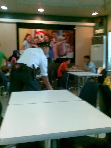 security guard - security guard seen arranging chairs after clearing a table in a fast food restaurant security guard - security guard seen arranging chairs after clearing a table in a fast food restaurant