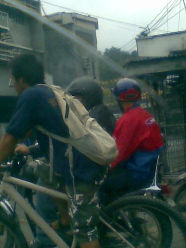 bikers - bicycle and motorcycle riders seen on a busy morning traffic in a main highway