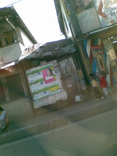 children - children in the side of a busy street. they are usually seen staying there most of the day.