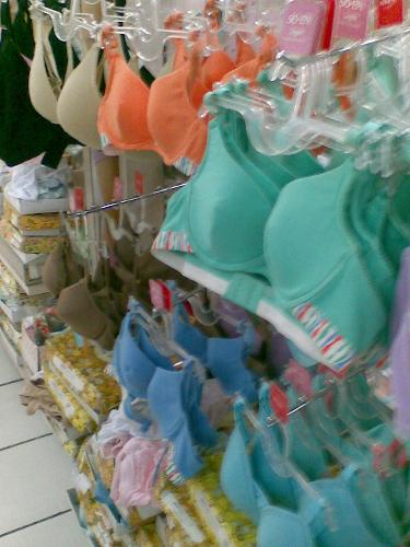 women's intimate apparel - bras and panties of different colors seen in a women's intimate apparel section of a department store