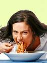 Eating - A women eating spaghetti