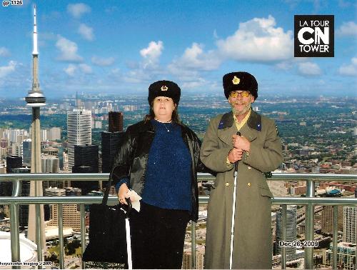 My Husband And I In Our Russian Hats... - ..and he has a Russian coat. This was taken at the CN Tower in Toronto, on December 26th, 2009.