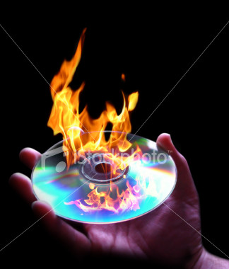 CD burning - The picture shows a disk is being burnt or you can say it catch fire. CD burning - The picture shows a disk is being burnt or you can say it catch fire.