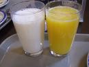 Which is more healthier milk or orange juice? - In this photo u can see glass of milk and orange juice.