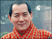 Bhutan - King Jigme wang chuk - Jigme Singye Wangchuk says he will abdicate and hand power to his son, Crown Prince Jigme Khesar Namgyel Wangchuck, in 2008.  He came to the throne in 1972 at the age of just 17, assuming the title of 'Druk Gyalpo' or Dragon King. Partly educated in Britain, and having travelled abroad, the king has continued the policy of limited modernisation adopted by his father.  He has also been keen to preserve Bhutan's unique culture.  He gave up some of the monarch's absolute powers in 1998 and now rules in conjunction with the government, an assembly and a royal advisory council.  He projects the image of one who maintains a simple lifestyle - preferring to work in a small log cabin above the capital, Thimphu, rather than in the fortress-like palace used by his four wives, all of whom are sisters.