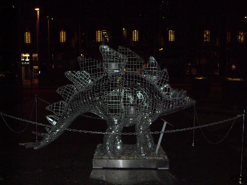 Pittsburgh 4 - The third and final in a series of dinosaur sculptures found in a square in the cultural district of Pittsburgh at nighttime. This abstract statue happens to be a stegosauras.