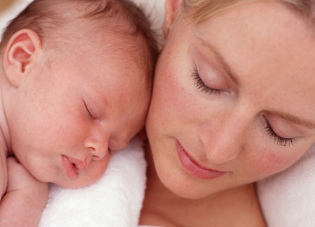 New Born Baby - New born baby laying on her mother.